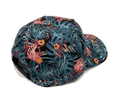 Baseball cap with a blue tropical leaf pattern and pink/orange accents, viewed from above/angle.
